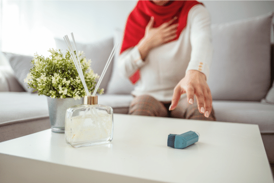 person reaching for asthma inhaler